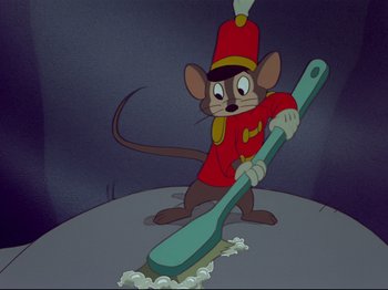 Movie still from “Dumbo” (1941), directed by Ben Sharpsteen – A mouse in a red uniform holding a giant toothbrush; Medium shot, Low angle