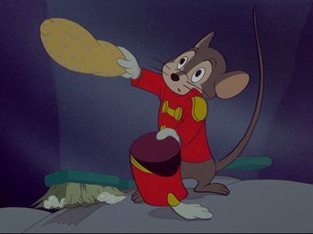 Movie still from “Dumbo” (1941), directed by Ben Sharpsteen – A mouse is holding a frisbee in his hand; Medium shot, Low angle