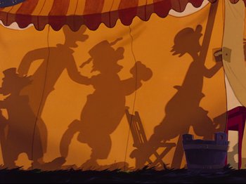Movie still from “Dumbo” (1941), directed by Ben Sharpsteen – A shadow of a man and a woman on a circus tent; Wide shot, Low angle