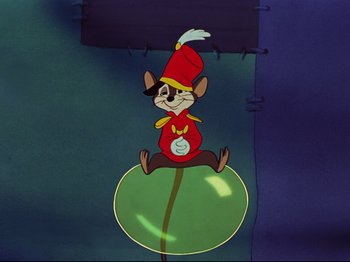 Movie still from “Dumbo” (1941), directed by Ben Sharpsteen – A mouse sitting on top of a green ball; Wide shot, High angle