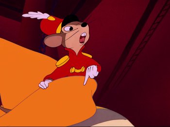 Movie still from “Dumbo” (1941), directed by Ben Sharpsteen – A cartoon of a mouse wearing a red outfit; Medium shot, Low angle