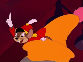 Movie still from “Dumbo” (1941), directed by Ben Sharpsteen – A cartoon of a mouse flying through the air with an orange tail; Wide shot, Low angle