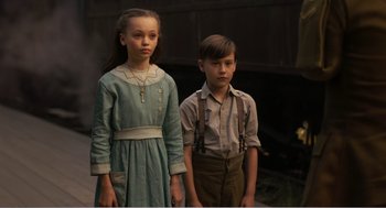 Movie still from “Dumbo” (2019), directed by Tim Burton – A young boy and a young girl standing next to each other; Medium shot, High angle