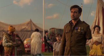 Movie still from “Dumbo” (2019), directed by Tim Burton – A man standing in front of a crowd of people in a field; Medium shot, Over the shoulder angle