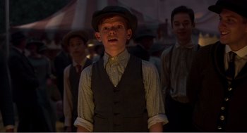 Movie still from “Dumbo” (2019), directed by Tim Burton – A group of young men standing next to each other; Medium shot, Low angle