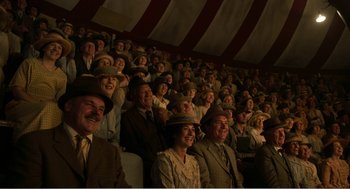 Movie still from “Dumbo” (2019), directed by Tim Burton – A group of people sitting in a stadium; Wide shot, High angle