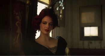 Movie still from “Dumbo” (2019), directed by Tim Burton – A woman with red hair wearing a black dress and a black hat; Close Up shot, Low angle