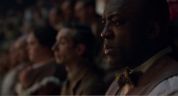 Movie still from “Dumbo” (2019), directed by Tim Burton – Two men are sitting in front of each other; Close Up shot, Over the shoulder angle