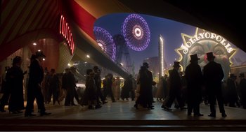 Movie still from “Dumbo” (2019), directed by Tim Burton – A group of people walking on the street at night; Extreme Wide shot, High angle