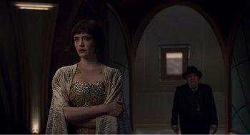 Movie still from “Dumbo” (2019), directed by Tim Burton – A woman standing in front of a man in a suit and tie; Medium shot, Over the shoulder angle