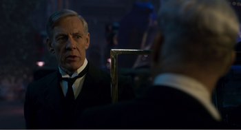 Movie still from “Dumbo” (2019), directed by Tim Burton – A man wearing a suit and tie looking at himself in the mirror; Close Up shot, Over the shoulder angle