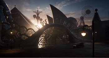 Movie still from “Dumbo” (2019), directed by Tim Burton – A ferris wheel and a ferris wheel in the background; Extreme Wide shot, High angle