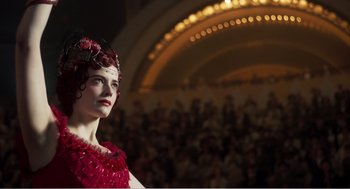 Movie still from “Dumbo” (2019), directed by Tim Burton – A woman in a red dress standing in front of an audience; Close Up shot, Low angle