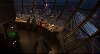 Movie still from “Dumbo” (2019), directed by Tim Burton – People are looking out of a control tower at a carnival; Wide shot, High angle