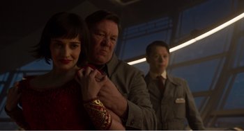 Movie still from “Dumbo” (2019), directed by Tim Burton – A man and a woman standing next to each other in a room; Medium shot, Low angle