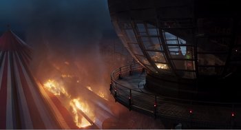 Movie still from “Dumbo” (2019), directed by Tim Burton – A fire is burning in a building on fire; Extreme Wide shot, High angle