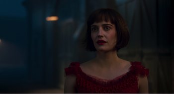 Movie still from “Dumbo” (2019), directed by Tim Burton – A woman in a red dress is looking at the camera; Close Up shot, Over the shoulder angle