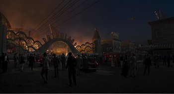 Movie still from “Dumbo” (2019), directed by Tim Burton – A group of people standing in a parking lot at night; Extreme Wide shot, High angle