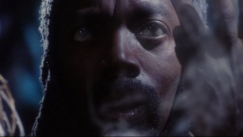 Movie still from “Dust Devil” (1992), directed by Richard Stanley – A man's eyes and face; Extreme Close Up shot, Low angle