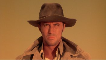 Movie still from “Dust Devil” (1992), directed by Richard Stanley – A person wearing a hat; Close Up shot, Low angle