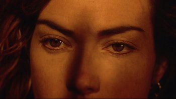 Movie still from “Dust Devil” (1992), directed by Richard Stanley – A woman's eyes with brown tint; Extreme Close Up shot, Overhead angle