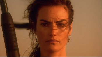 Movie still from “Dust Devil” (1992), directed by Richard Stanley – A person wearing a earring; Close Up shot, Low angle