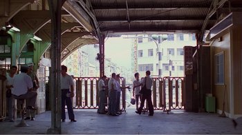 Movie still from “Dust in the Wind” (1986), directed by Hsiao-Hsien Hou – A group of people standing on top of a train platform; Extreme Wide shot, High angle