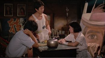 Movie still from “Dust in the Wind” (1986), directed by Hsiao-Hsien Hou – A group of people sitting around a table; Medium shot, Over the shoulder angle