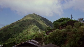Movie still from “Dust in the Wind” (1986), directed by Hsiao-Hsien Hou – A view of a mountain from a hill side; Extreme Wide shot, High angle