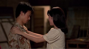 Movie still from “Dust in the Wind” (1986), directed by Hsiao-Hsien Hou – A man and a woman touching each other's chest; Medium shot, Low angle
