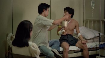 Movie still from “Dust in the Wind” (1986), directed by Hsiao-Hsien Hou – Two men sitting on a bed and one of the men is holding a cup; Medium shot, Over the shoulder angle
