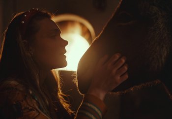 Movie still from “EO” (2022), directed by Jerzy Skolimowski – A woman is kissing a horse's face; Close Up shot, Over the shoulder angle