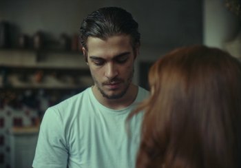 Movie still from “EO” (2022), directed by Jerzy Skolimowski – A man and a woman standing next to each other; Close Up shot, Over the shoulder angle