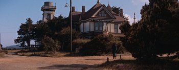 Movie still from “East of Eden” (1955), directed by Elia Kazan – An old house with a woman walking down the street; Extreme Wide shot, Low angle