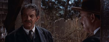Movie still from “East of Eden” (1955), directed by Elia Kazan – A man standing in front of a wooden fence; Close Up shot, Over the shoulder angle