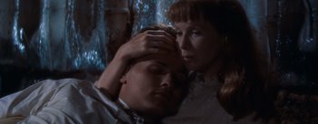 Movie still from “East of Eden” (1955), directed by Elia Kazan – A man and a woman embracing in a dark room; Close Up shot, High angle