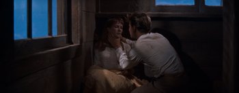 Movie still from “East of Eden” (1955), directed by Elia Kazan – A man and a woman are sitting in a room; Medium shot, High angle