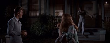 Movie still from “East of Eden” (1955), directed by Elia Kazan – A woman is standing in front of a window; Medium shot, Over the shoulder angle