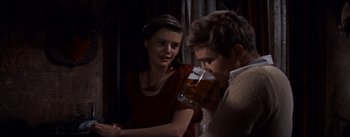Movie still from “East of Eden” (1955), directed by Elia Kazan – A man and a woman are drinking a beer together; Medium shot, Over the shoulder angle