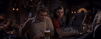 Movie still from “East of Eden” (1955), directed by Elia Kazan – A man and a woman sitting at a table with a beer; Medium shot, Over the shoulder angle