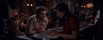 Movie still from “East of Eden” (1955), directed by Elia Kazan – A man and a woman sitting at a table; Medium shot, Over the shoulder angle