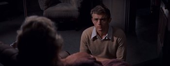 Movie still from “East of Eden” (1955), directed by Elia Kazan – A man sitting in front of another man in a room; Medium shot, Over the shoulder angle
