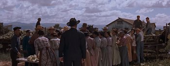 Movie still from “East of Eden” (1955), directed by Elia Kazan – A group of people standing in front of each other; Wide shot, Low angle