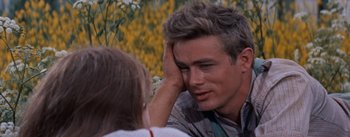 Movie still from “East of Eden” (1955), directed by Elia Kazan – A man and a woman sitting in front of each other; Close Up shot, Over the shoulder angle