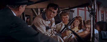 Movie still from “East of Eden” (1955), directed by Elia Kazan – A man sitting in a car while holding a steering wheel; Medium shot, Over the shoulder angle
