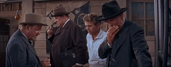 Movie still from “East of Eden” (1955), directed by Elia Kazan – A group of men standing next to each other on a street; Medium shot, Low angle