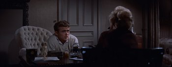 Movie still from “East of Eden” (1955), directed by Elia Kazan – A man sitting at a table with a woman; Medium shot, Over the shoulder angle