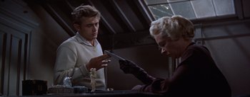 Movie still from “East of Eden” (1955), directed by Elia Kazan – A man and a woman are looking at a knife; Medium shot, Low angle