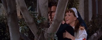 Movie still from “East of Eden” (1955), directed by Elia Kazan – A man and a woman standing next to a tree; Medium shot, Low angle