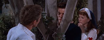 Movie still from “East of Eden” (1955), directed by Elia Kazan – A young man looking at himself in a mirror; Medium shot, Over the shoulder angle